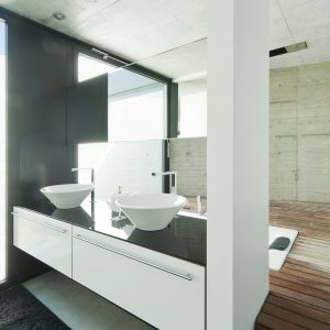 Interior of a modern bathroom with concrete walls and white furniture